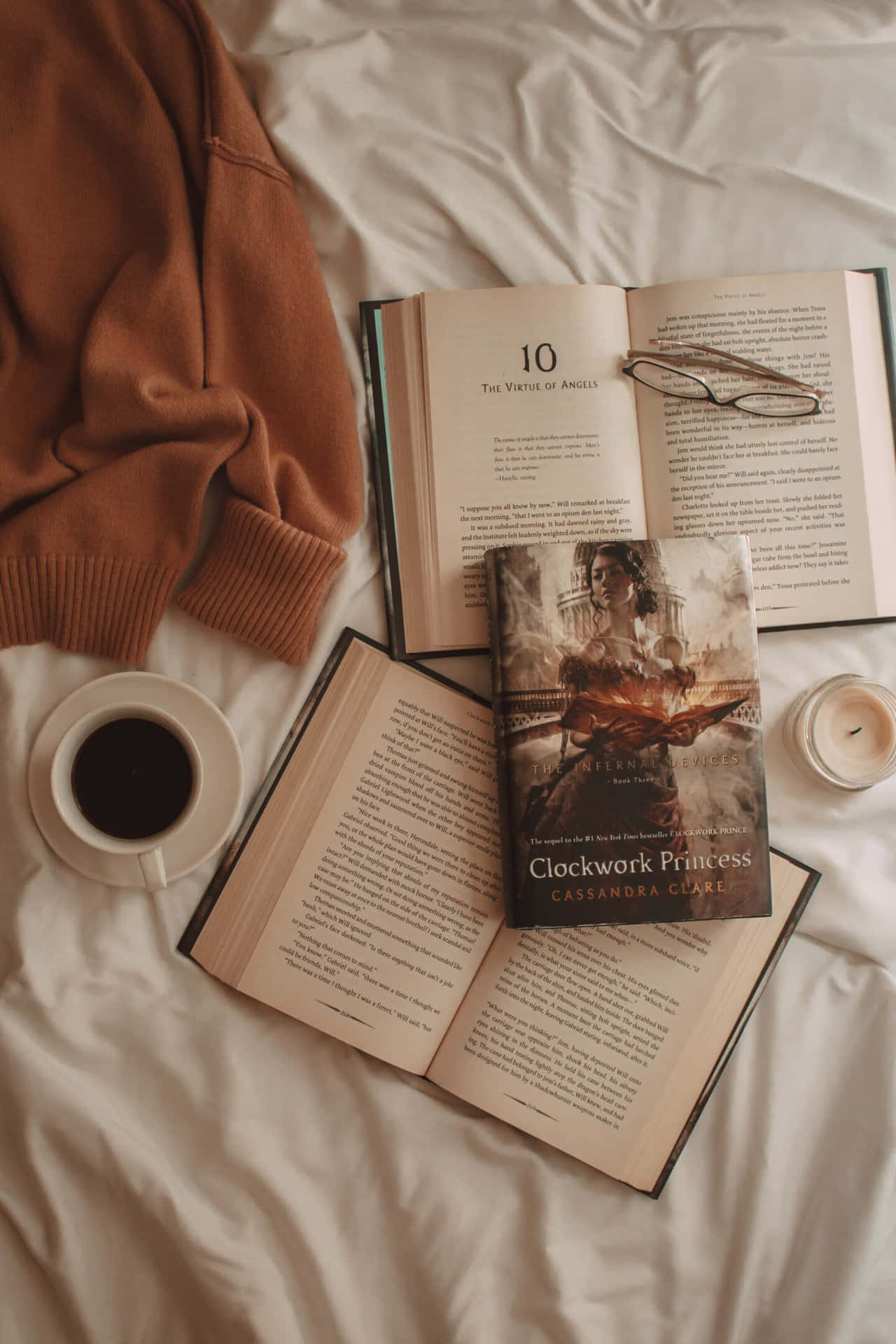 A Book, Coffee, And Glasses On A Bed
