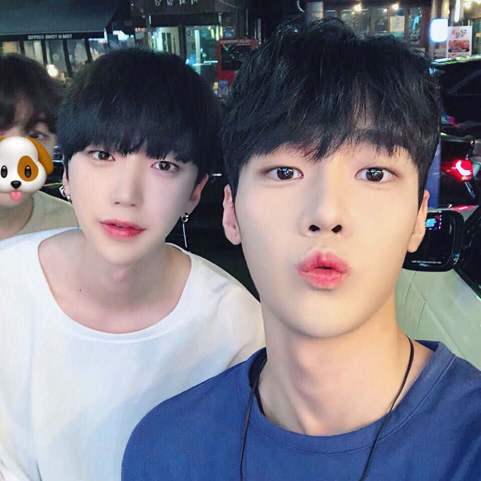 Two Korean Boys Are Posing For A Selfie
