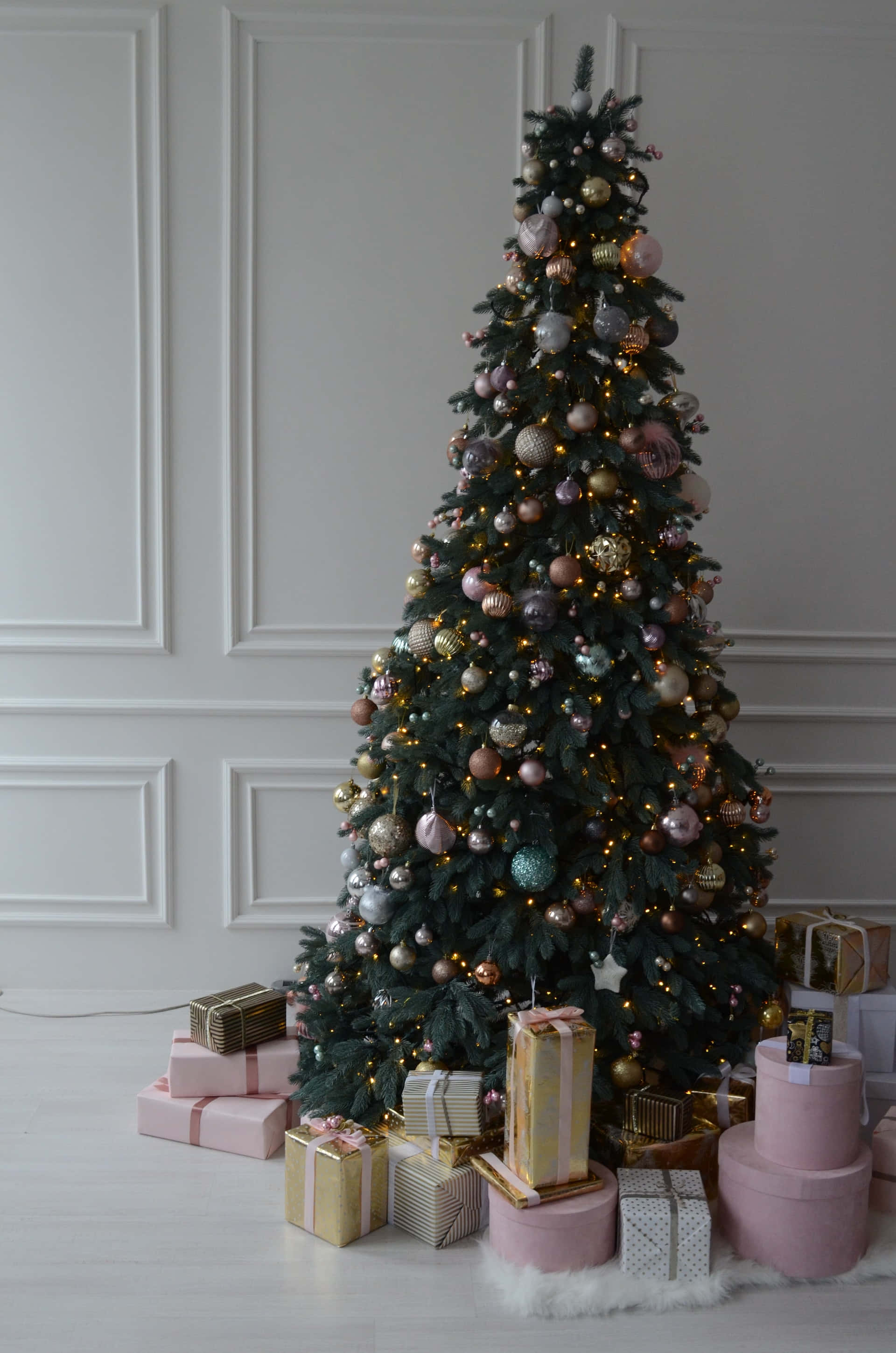 A Christmas Tree With Presents On The Floor Wallpaper