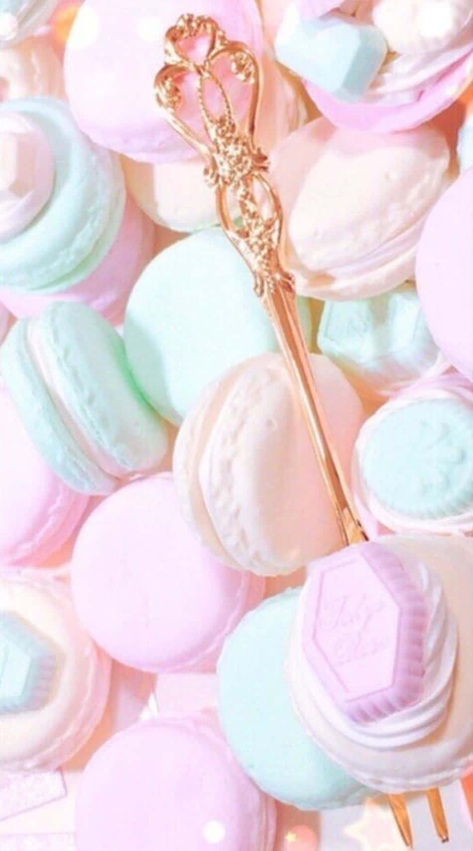 A Plate Of Macarons With A Gold Fork Wallpaper