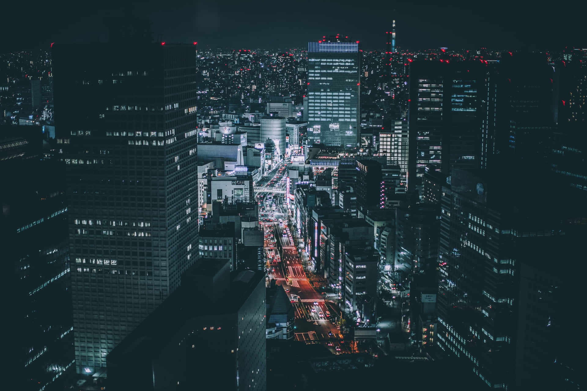 A City At Night With Lights And Buildings Wallpaper