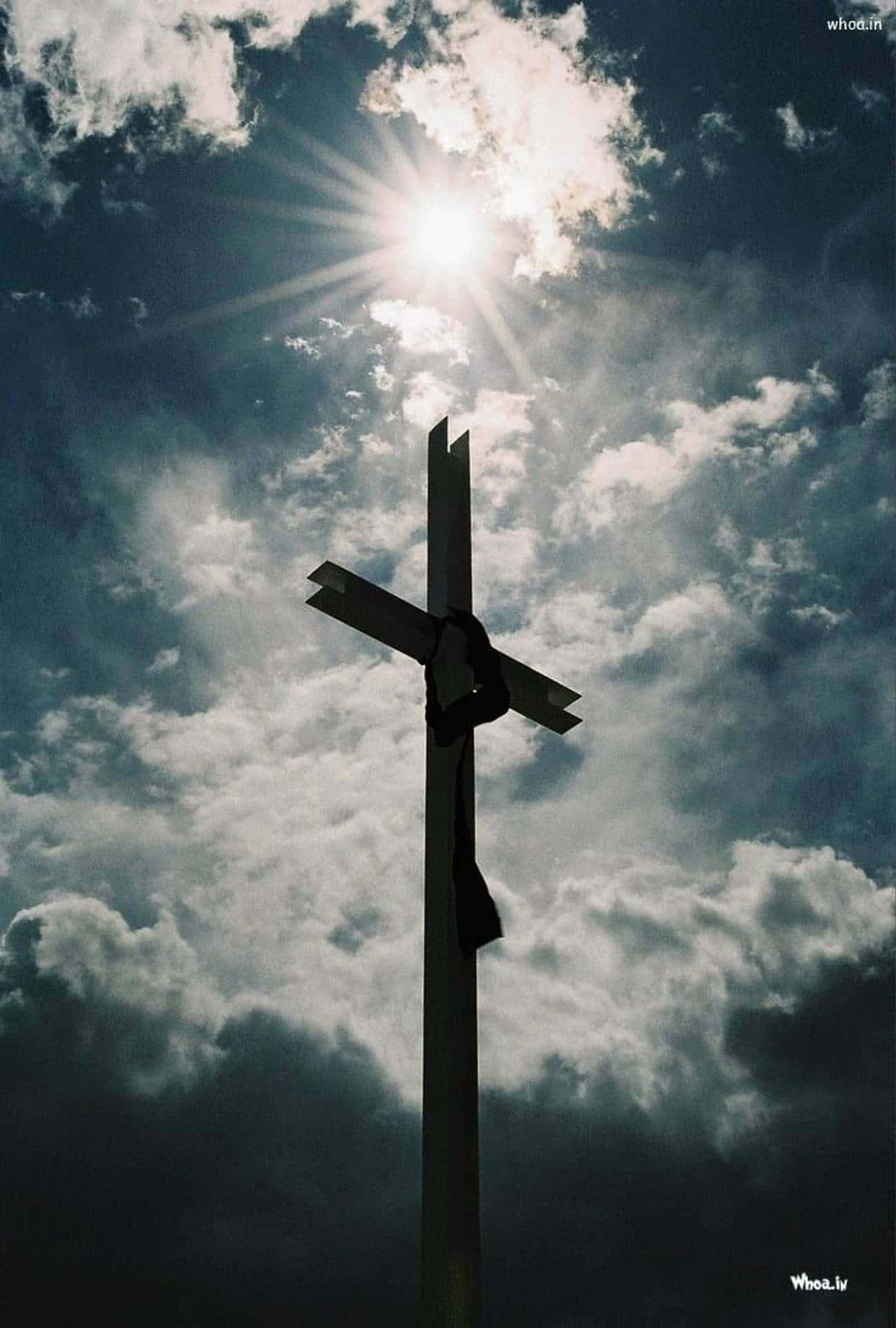 A Cross With Clouds In The Sky Wallpaper