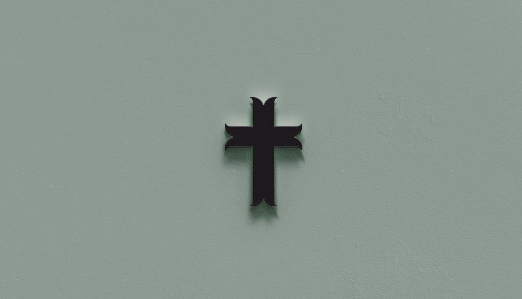 En sort kors er placeret på en mur af gråhvid. Wallpaper