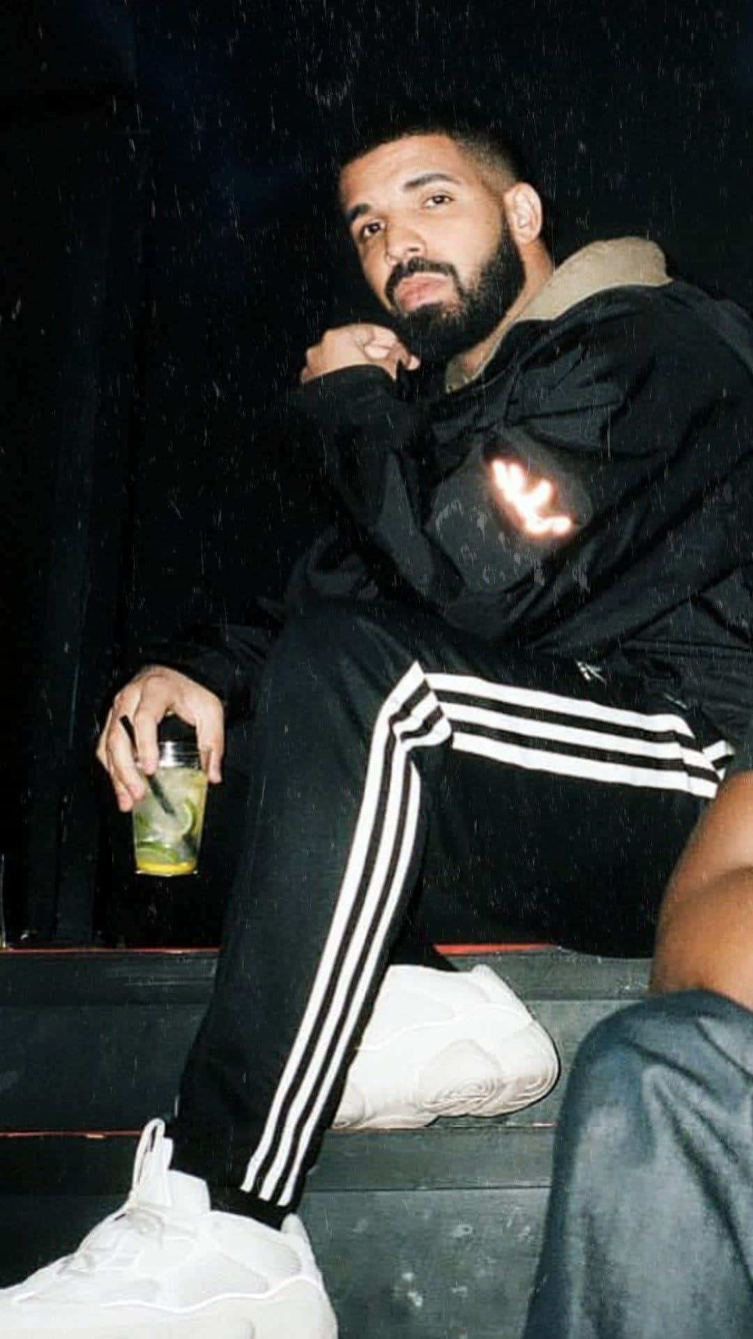 Drake And A Man Sitting On A Step Wallpaper