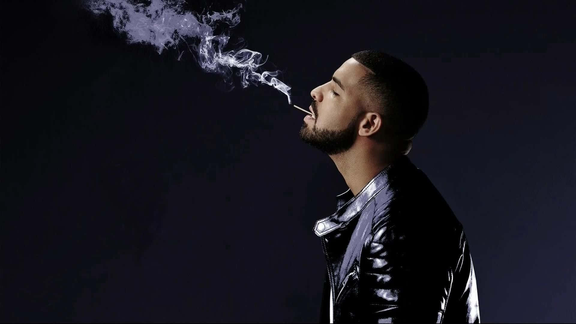 Drake Smokes A Cigarette In Black Leather Jacket Wallpaper