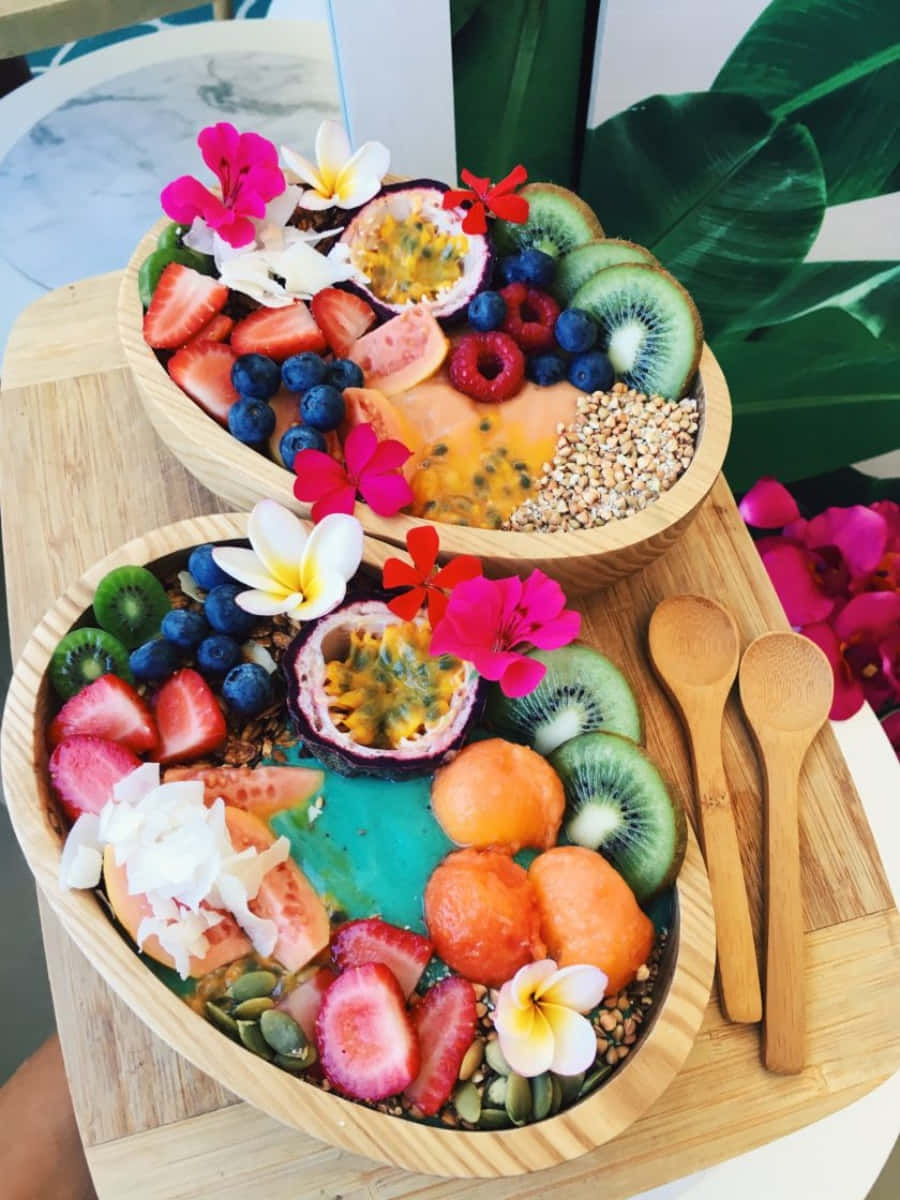 Two Bowls Of Fruit On A Wooden Tray