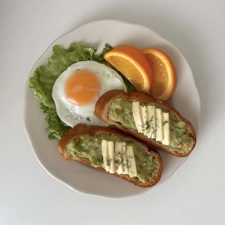 A Plate With Bread, Eggs And Oranges
