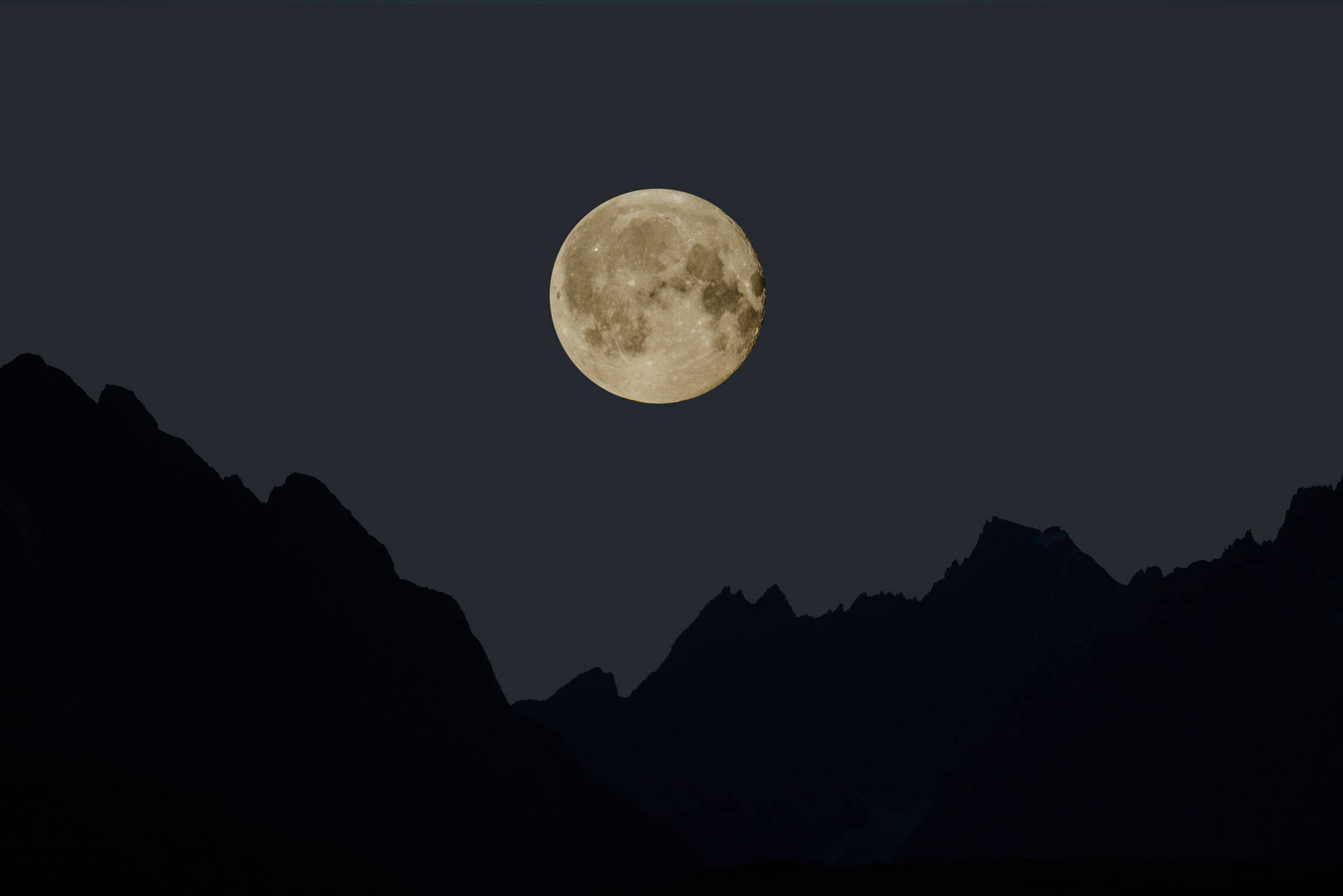 Aesthetic wallpaper of yellow full moon and mountain silhouette. 