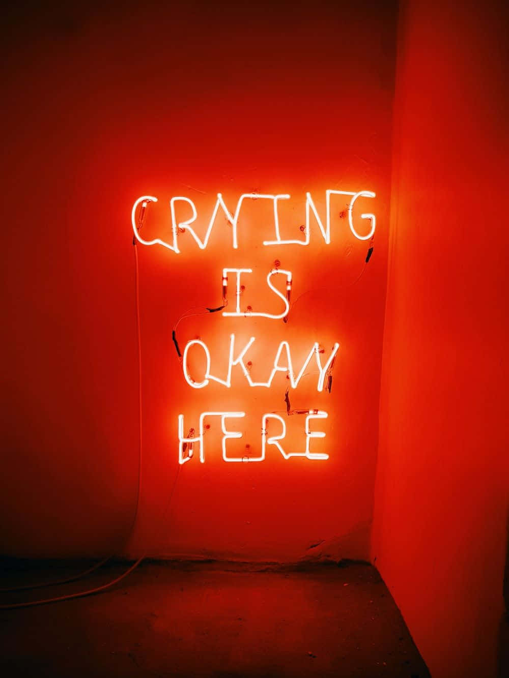 A Neon Sign That Says Crying Is Okay Here Wallpaper
