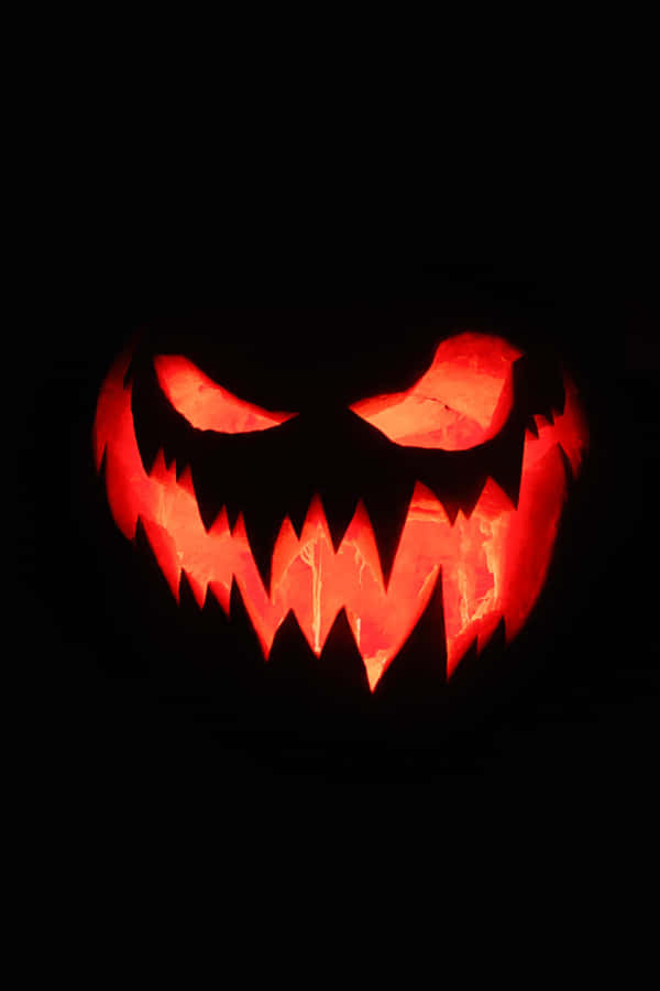 Aesthetic Halloween Background Smirking Evil Pumpkin Background