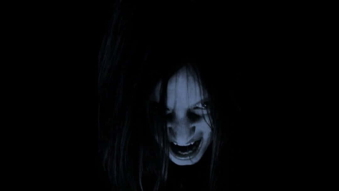 A Woman With Long Hair And A Scary Face Wallpaper