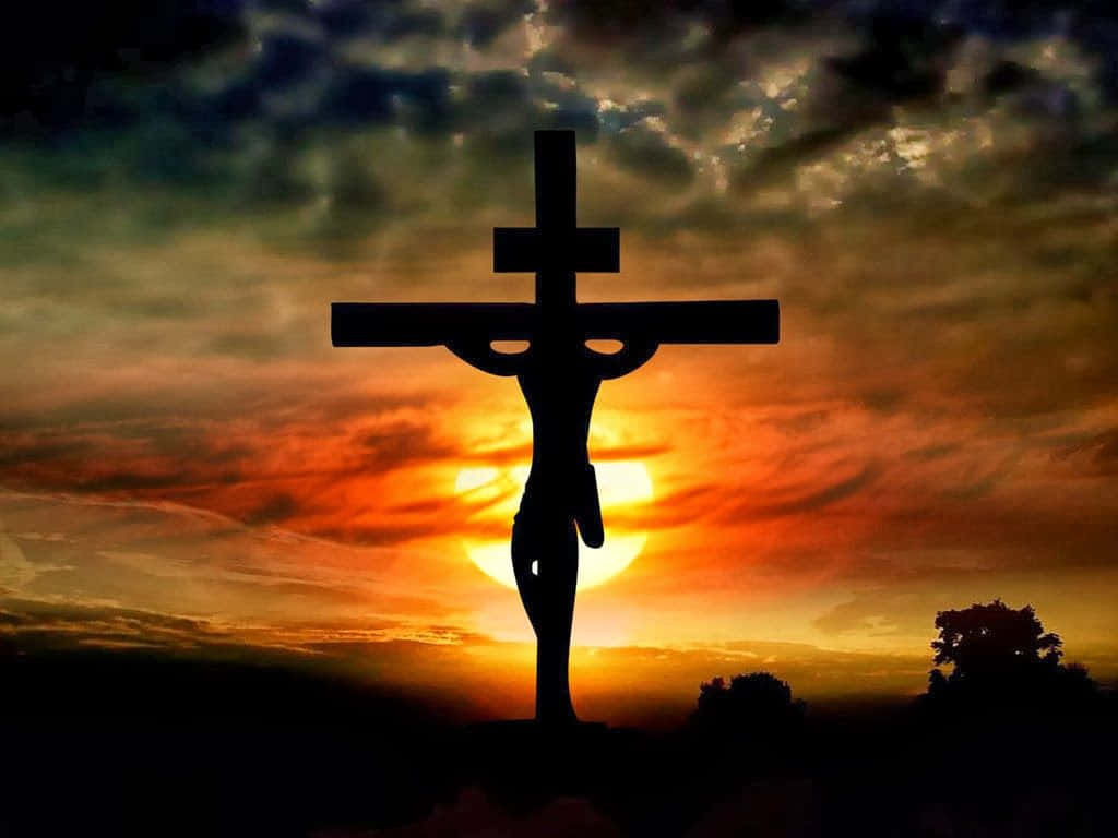 Æstetisk Jesus på korset ved solnedgang Wallpaper