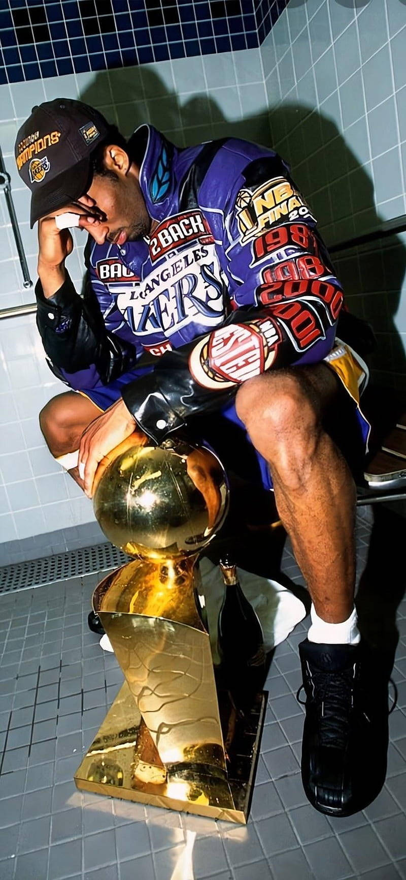 A Man Sitting On A Toilet With A Trophy Wallpaper