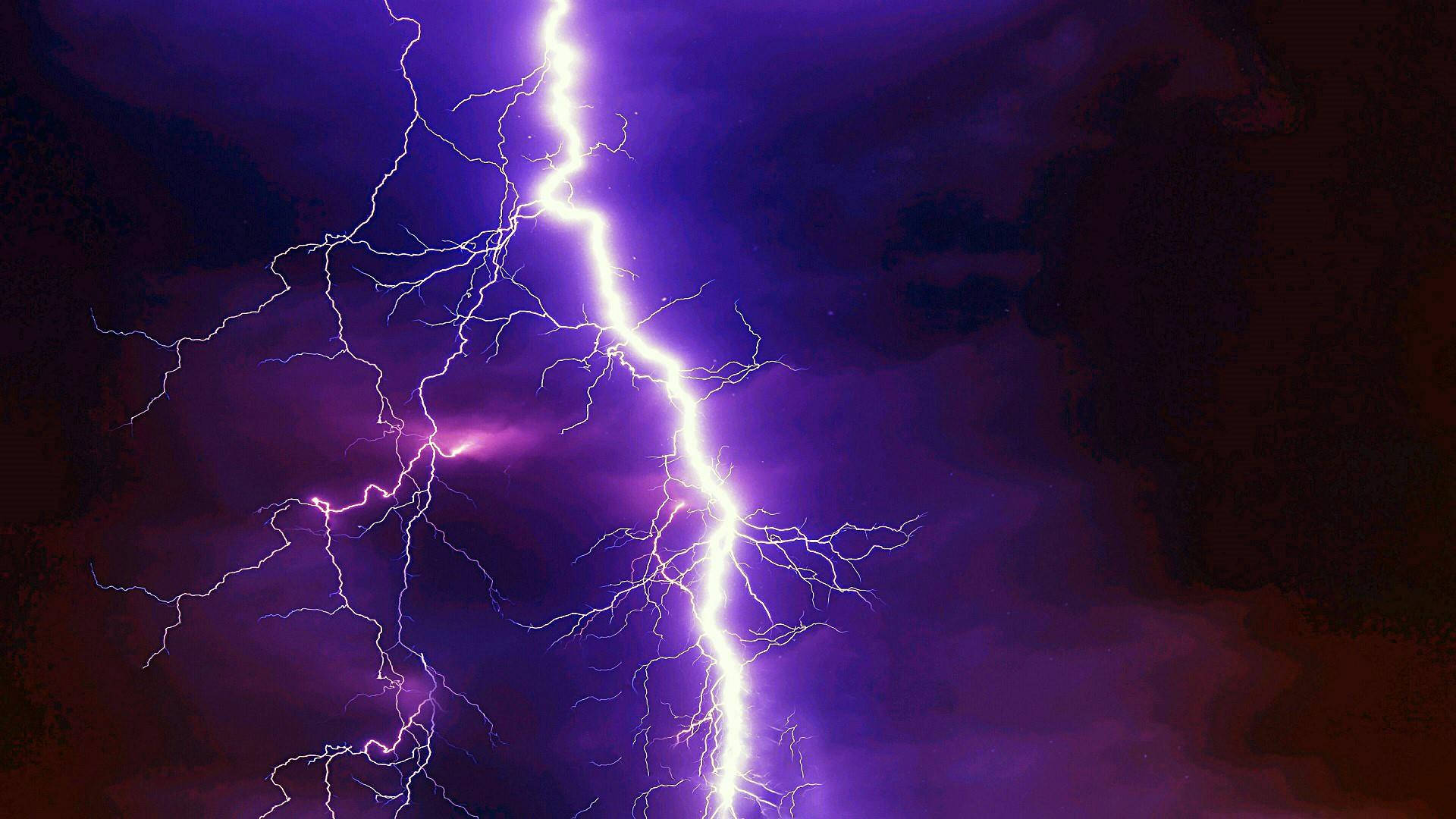 Capture the Beauty of the Lightning in the Night Sky Wallpaper