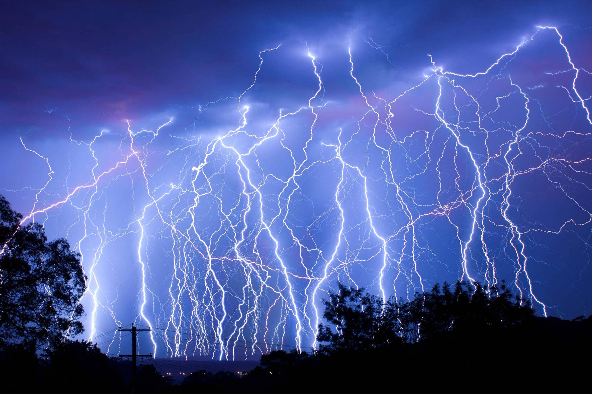 A shot of an eye-catching lightning strike in a night sky Wallpaper