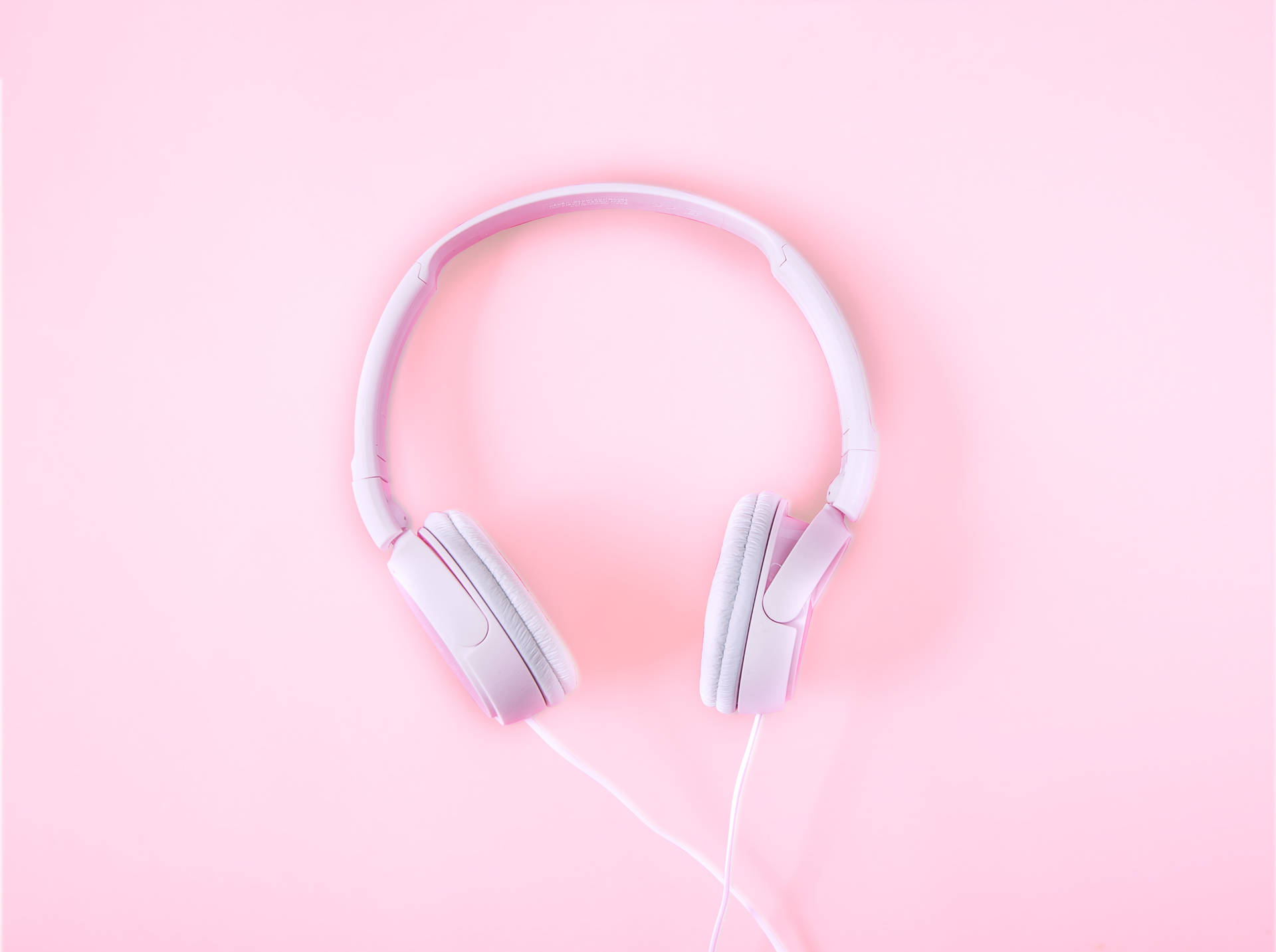 Experience the beauty of music with our pink headphones. Wallpaper
