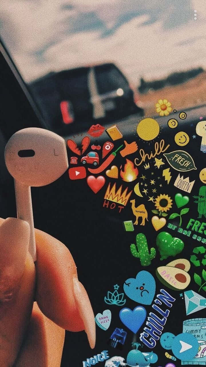 A Person Is Holding A Phone With Stickers On It