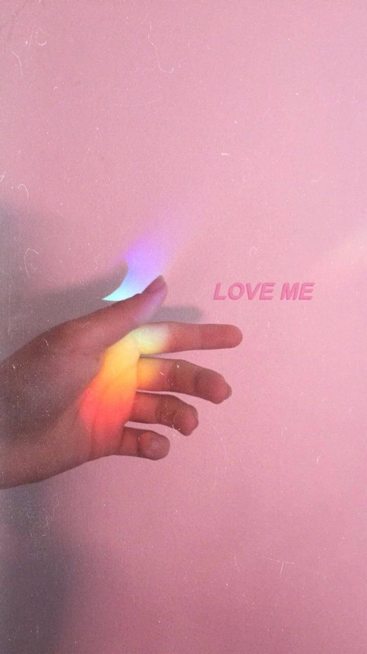 Aesthetic Pink Iphone Hand With Prism Light Wallpaper