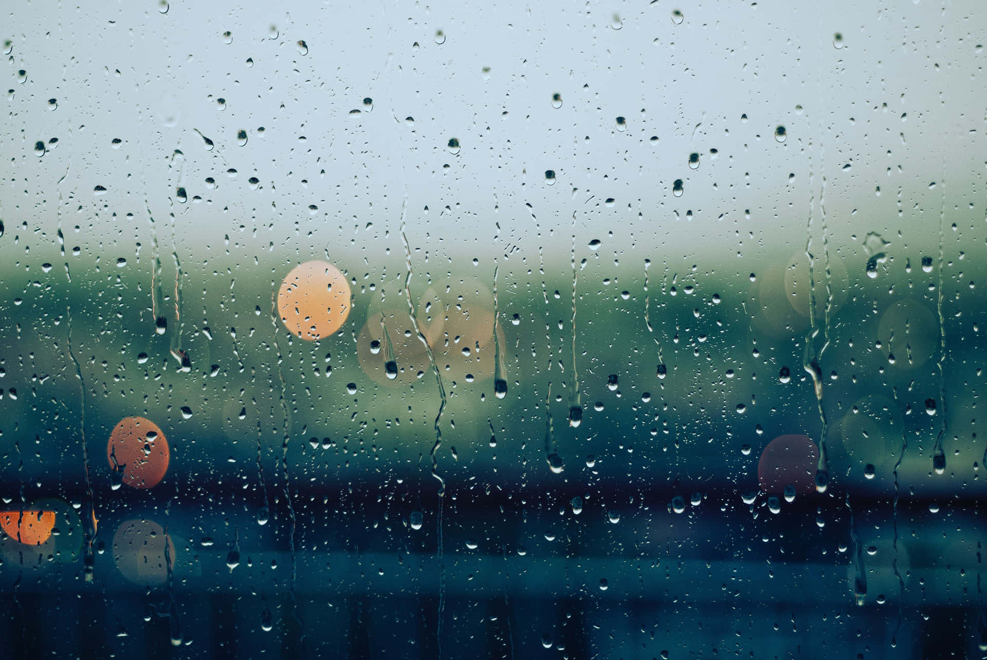 Aesthetic Raindrops On Blurry Car Window Wallpaper