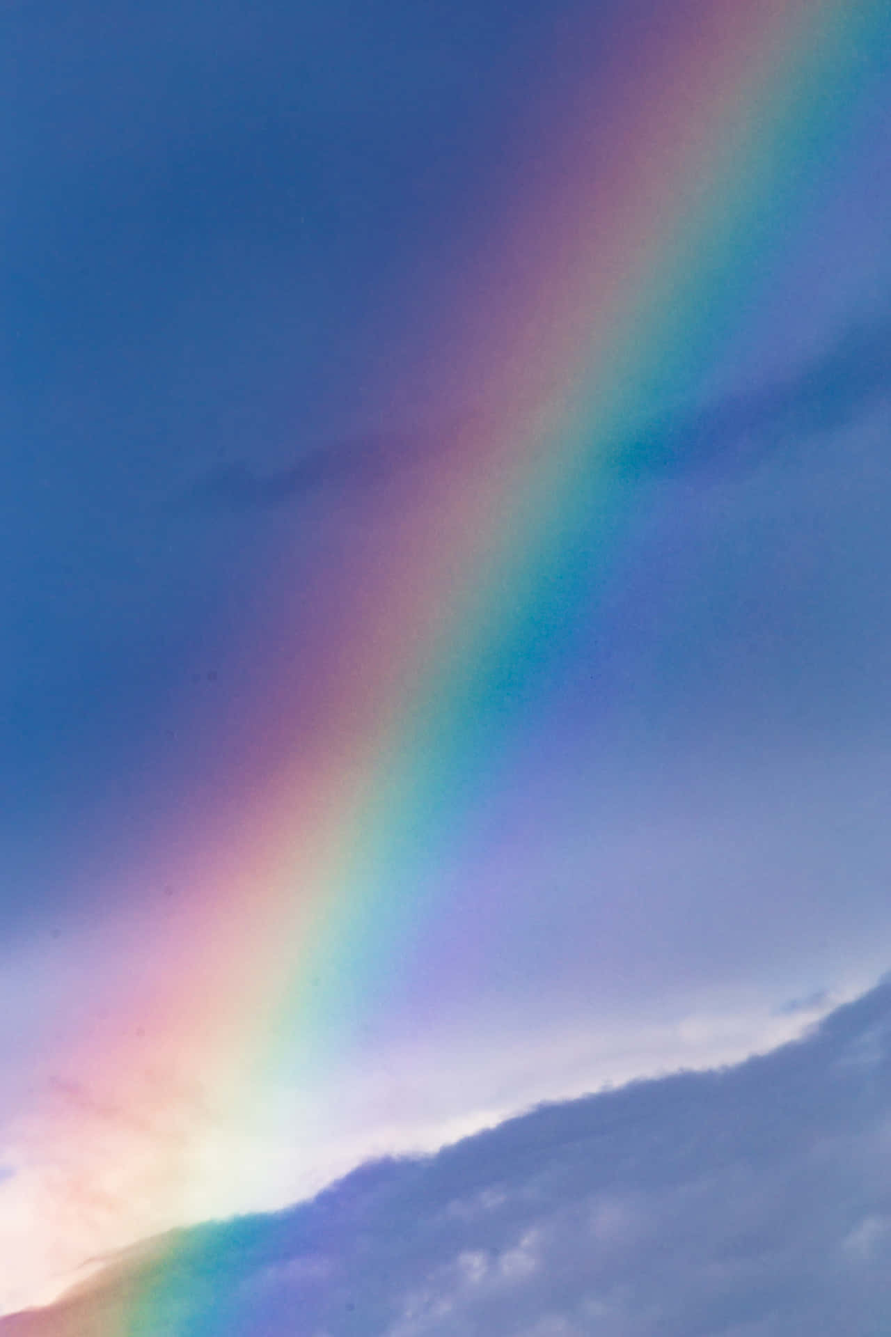 A Rainbow Is Seen In The Sky Above A Field Wallpaper