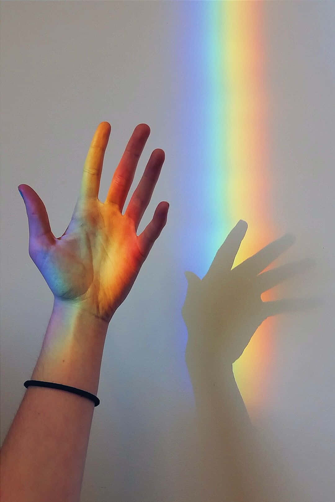 Hand Playing With The Aesthetic Rainbow Mobile Wallpaper