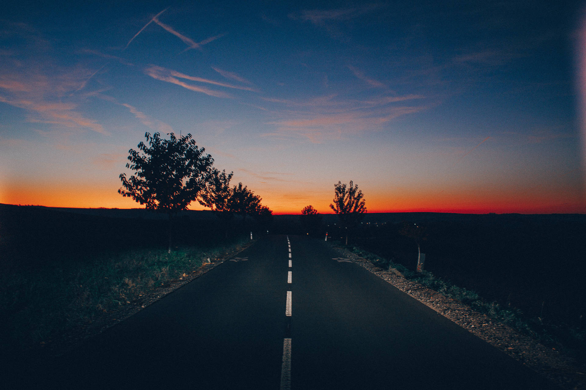 Aesthetic Sky Above Empty Road With Trees Wallpaper