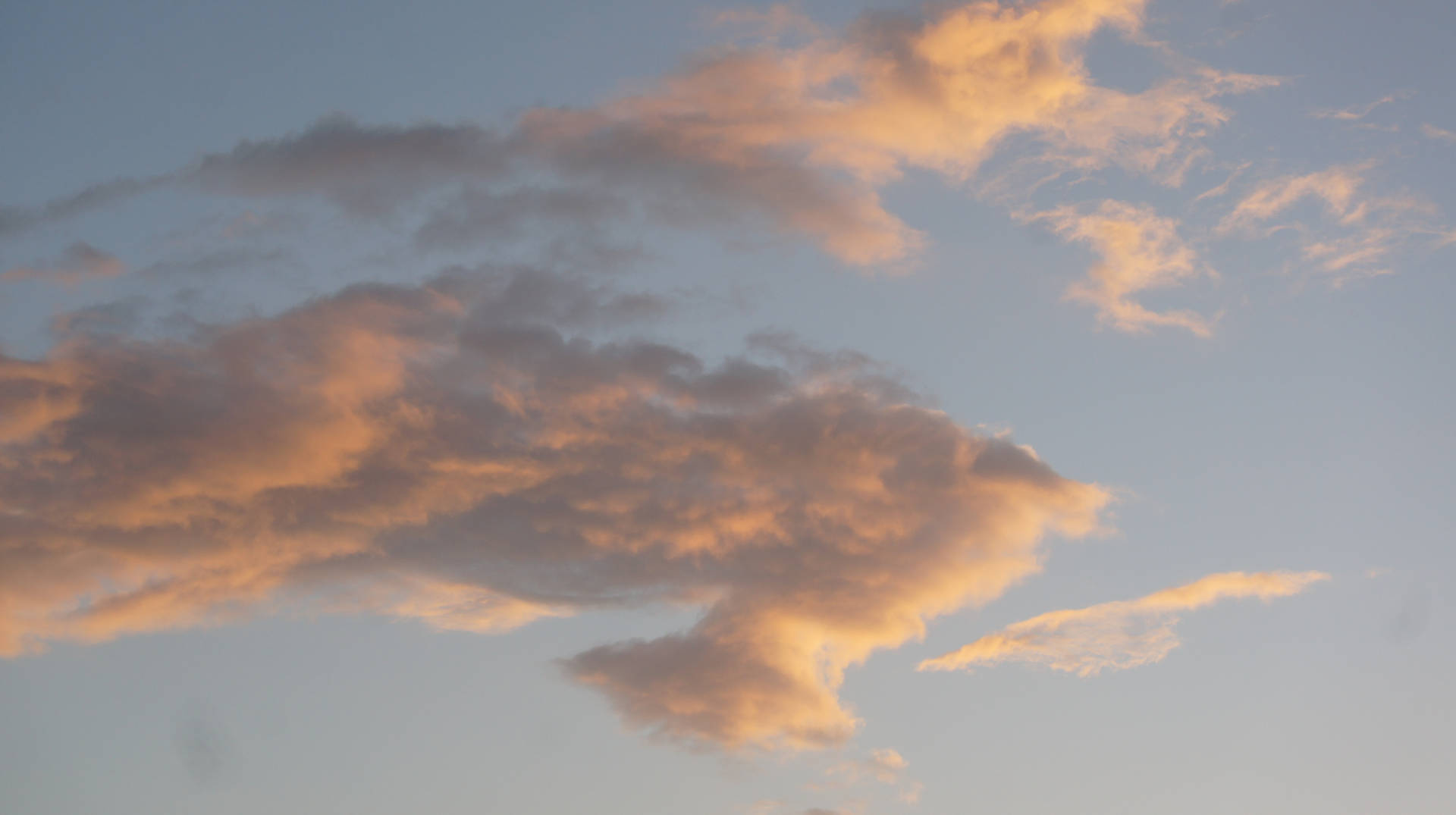 Aesthetic wallpaper of orange and white clouds during dusk. 