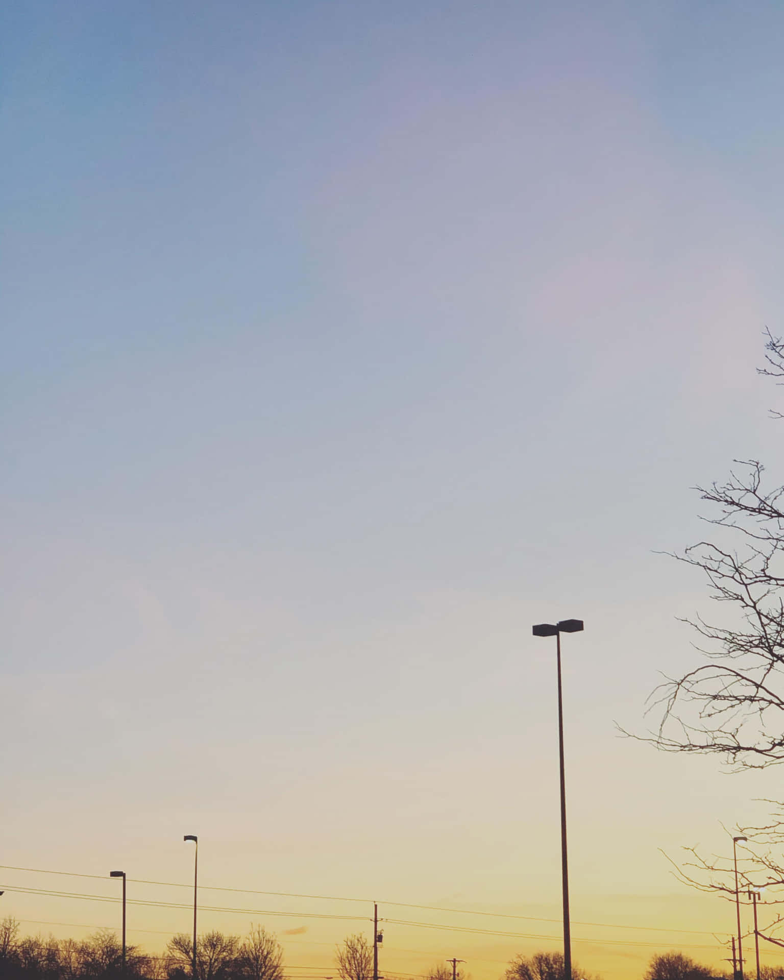 A Man Is Flying A Kite In A Parking Lot