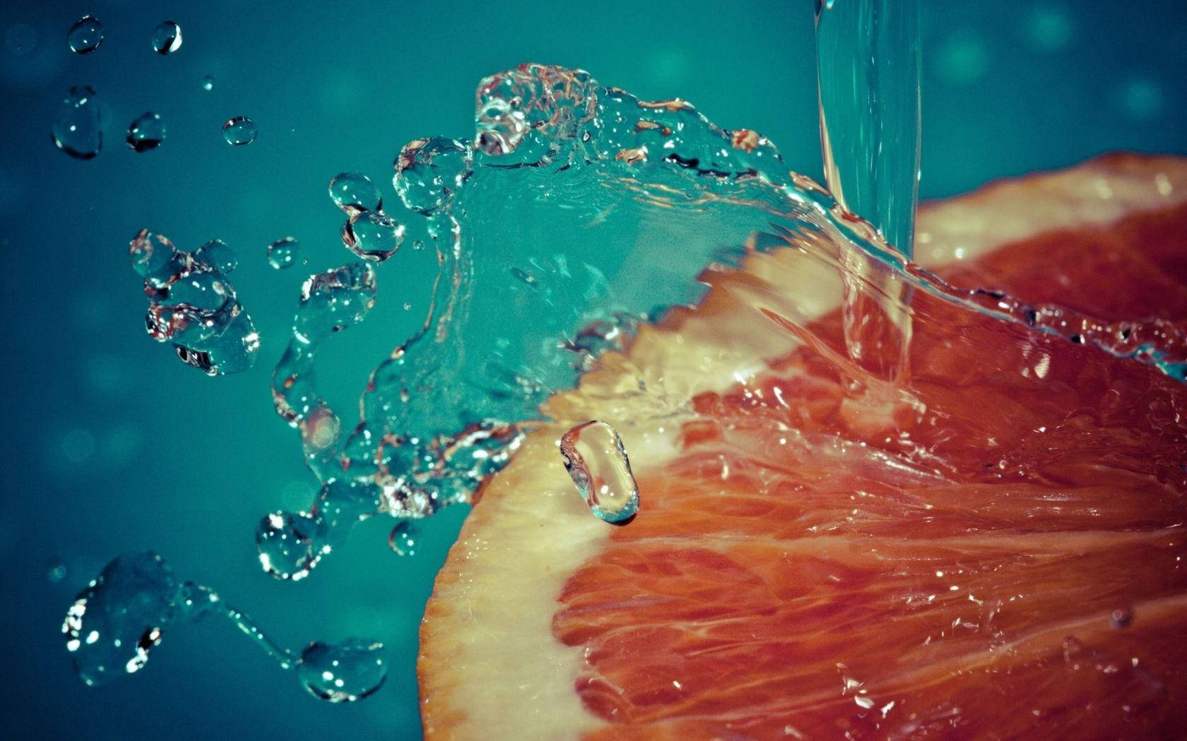 Æstetisk skivede grapefrugt vand splash Wallpaper