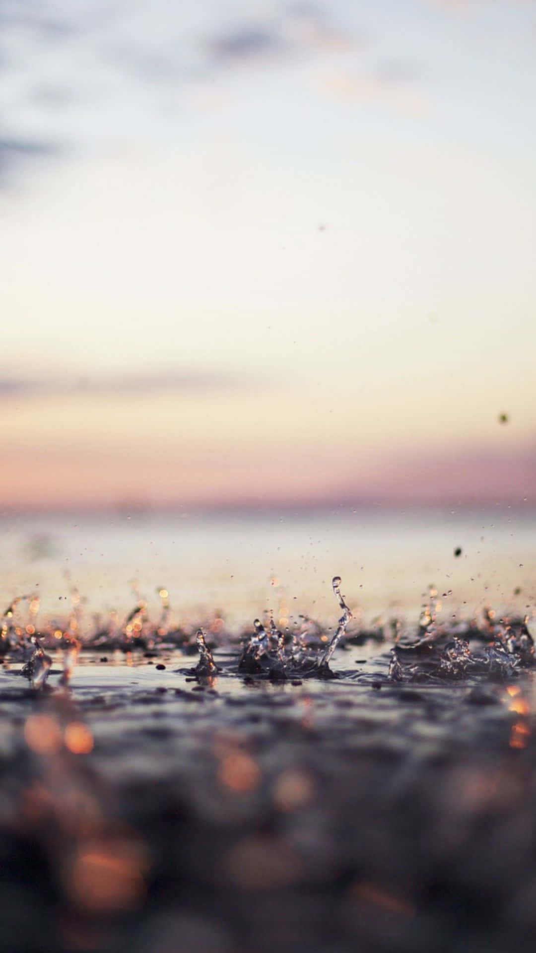 Water Splashes On The Beach At Sunset Wallpaper