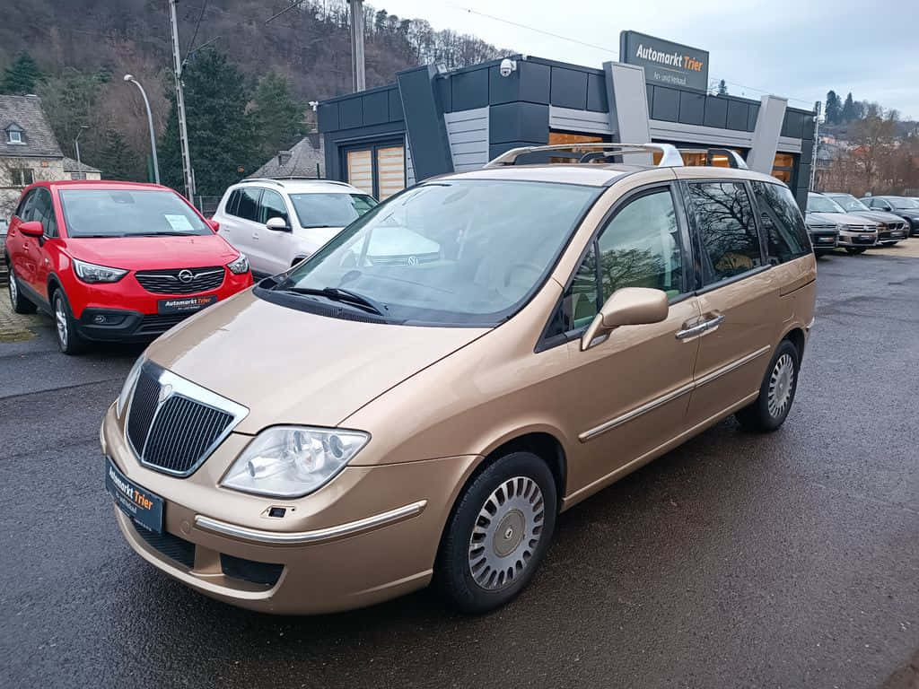 Aesthetic View Of A Lancia Phedra In An Open Ground Wallpaper