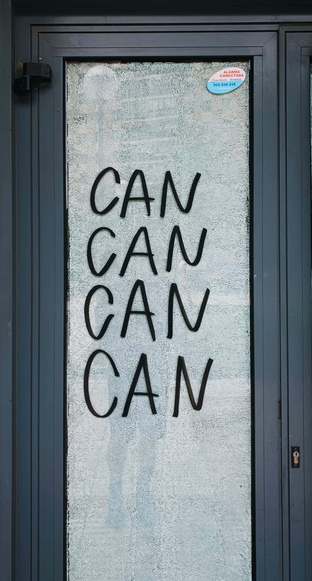 A Glass Door With The Words Can Can On It