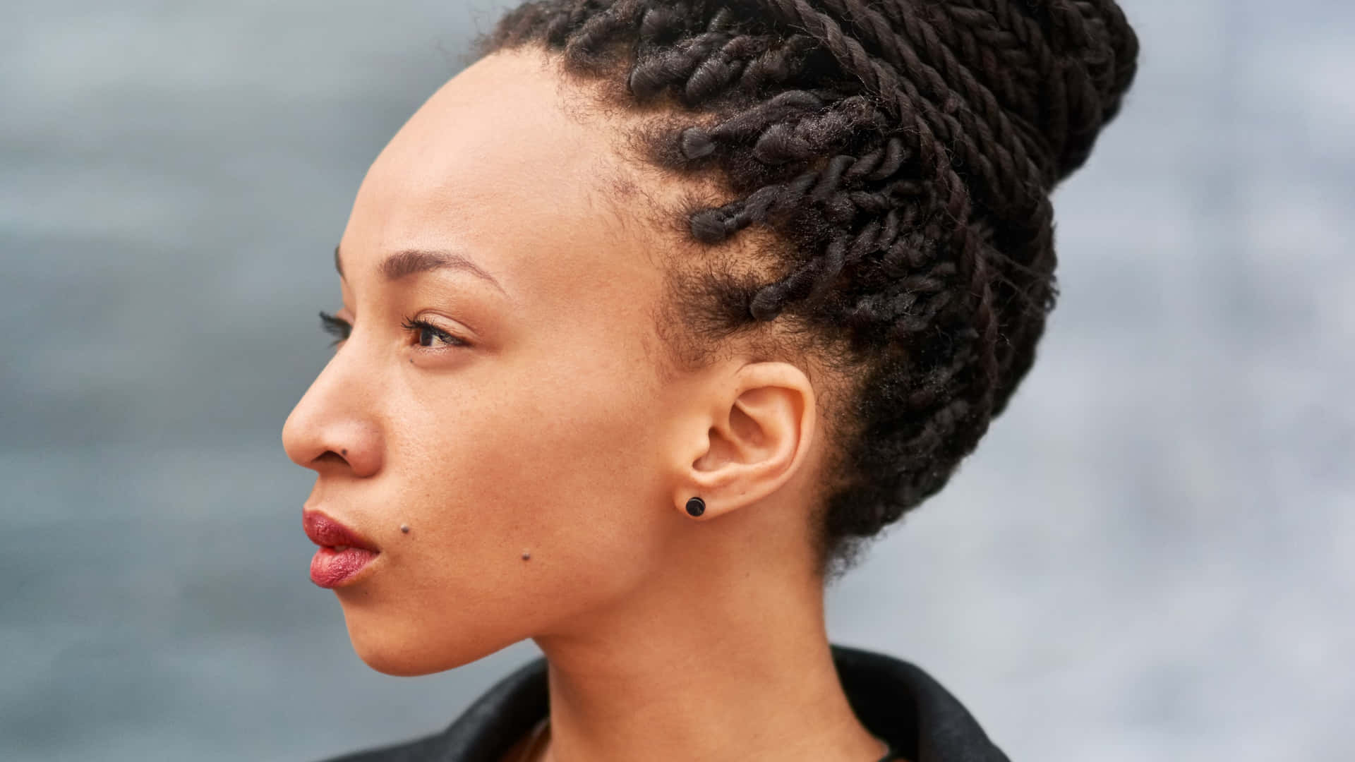 A Young Woman With A Braided Hairstyle