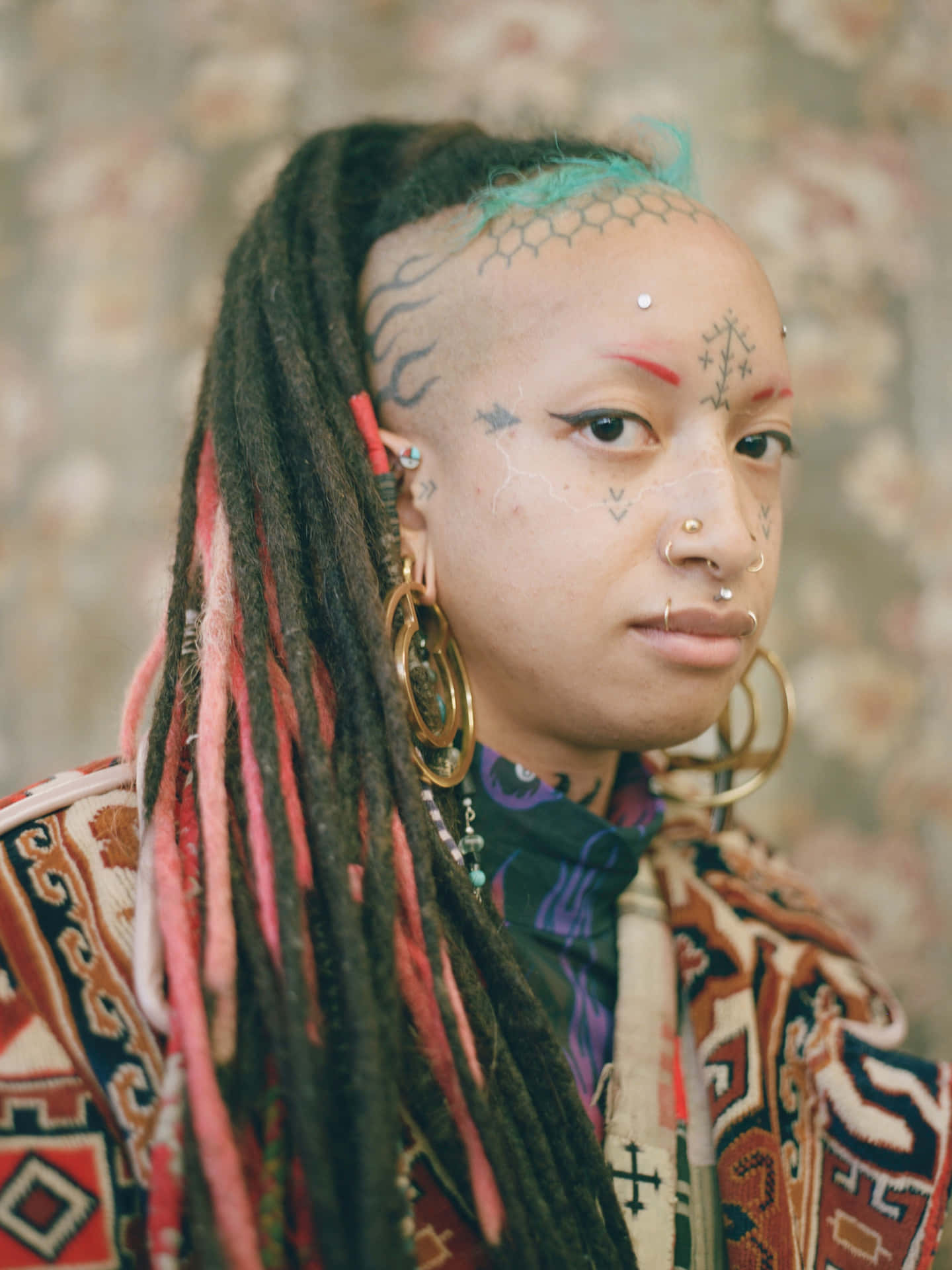 A Woman With Dreadlocks And Piercings