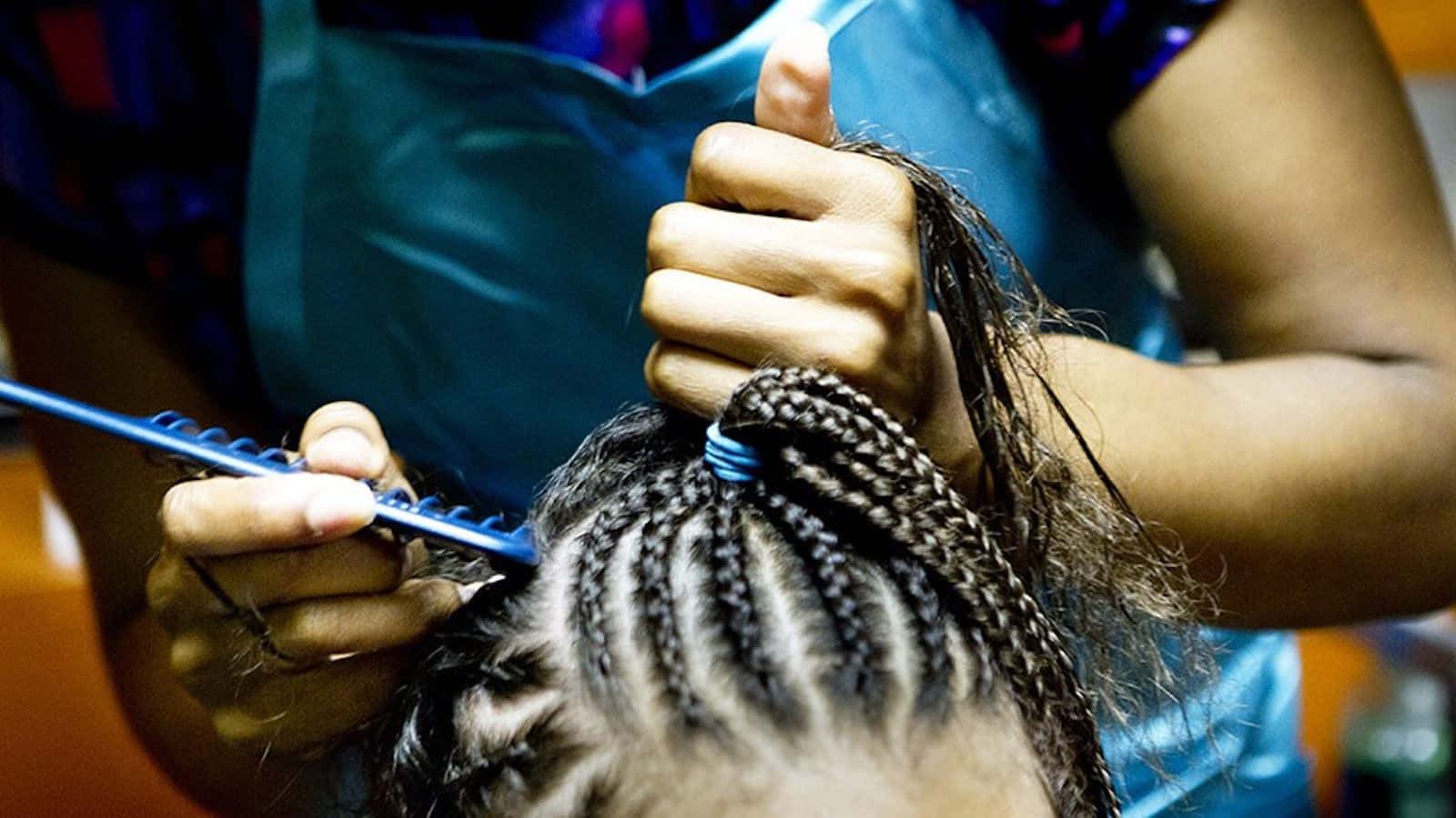 A Woman Is Cutting A Girl's Hair