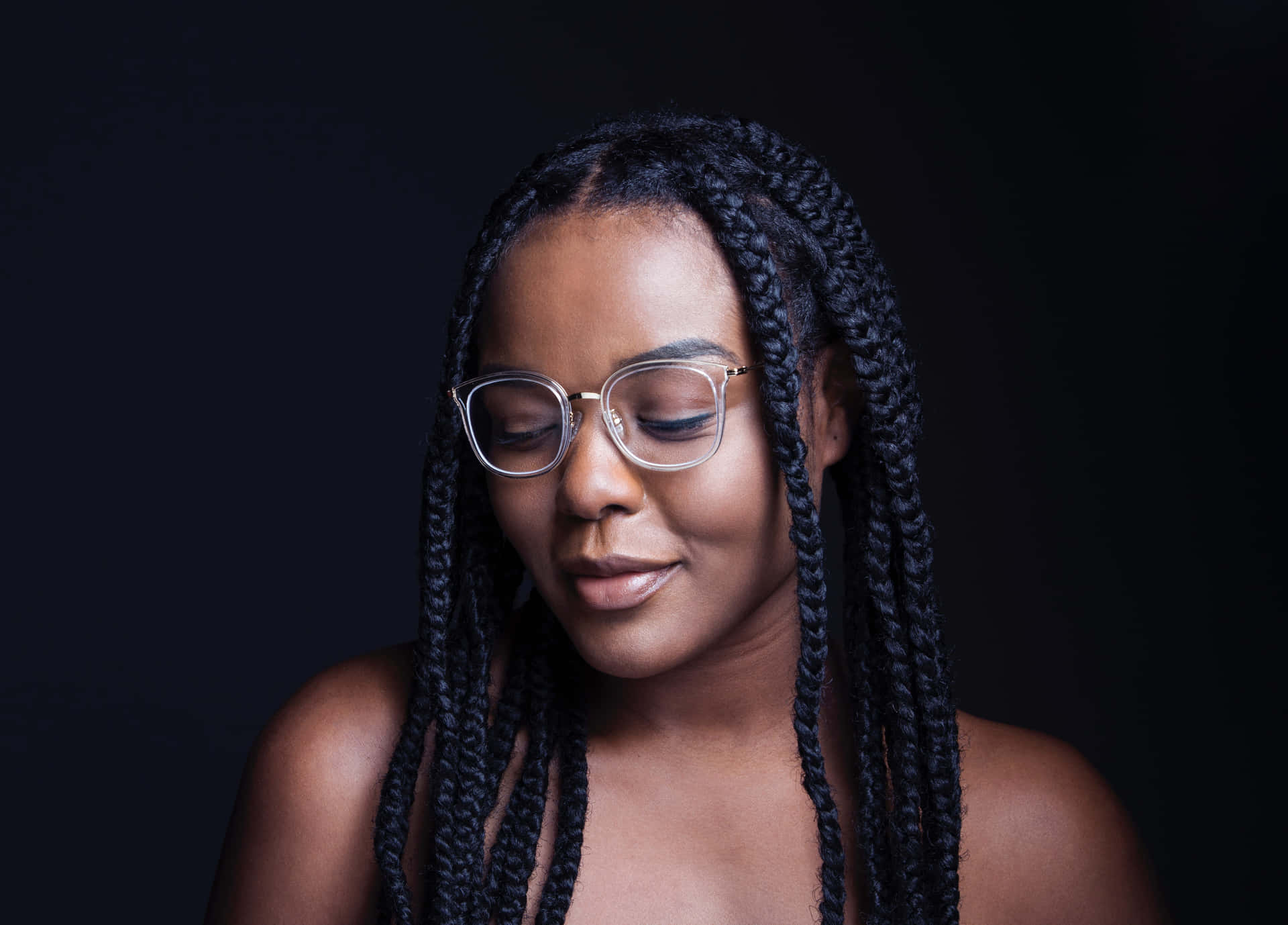 A Young Woman With Braids And Glasses