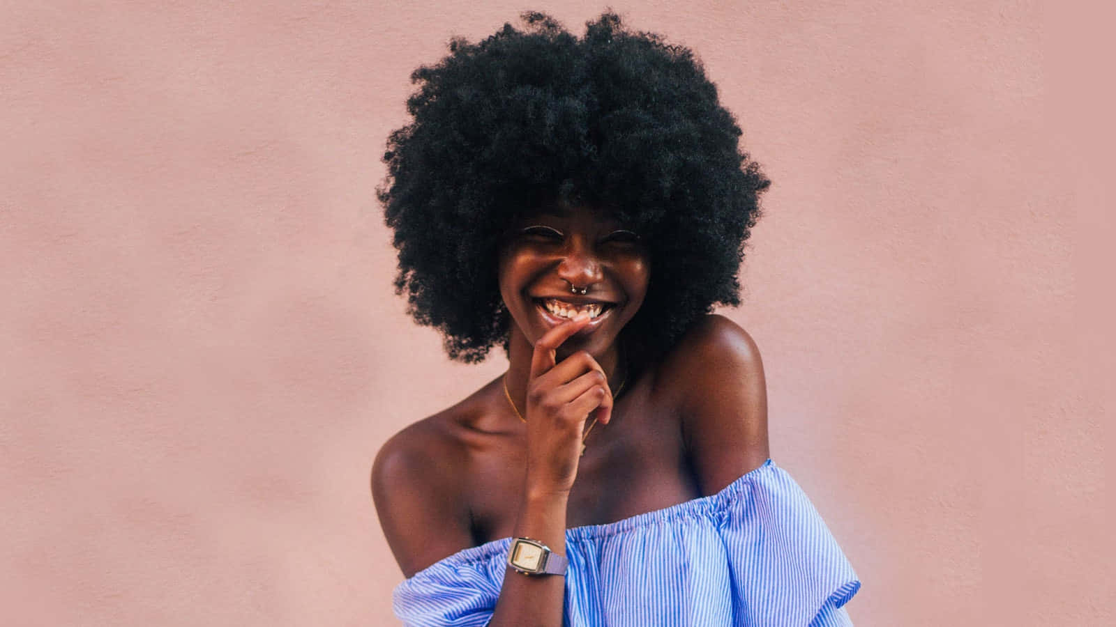A Woman With Afro Hair Smiling