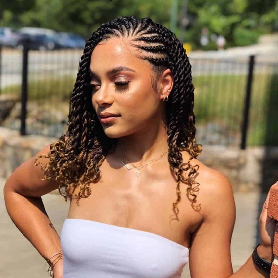 A Woman With A White Tank Top And Braids