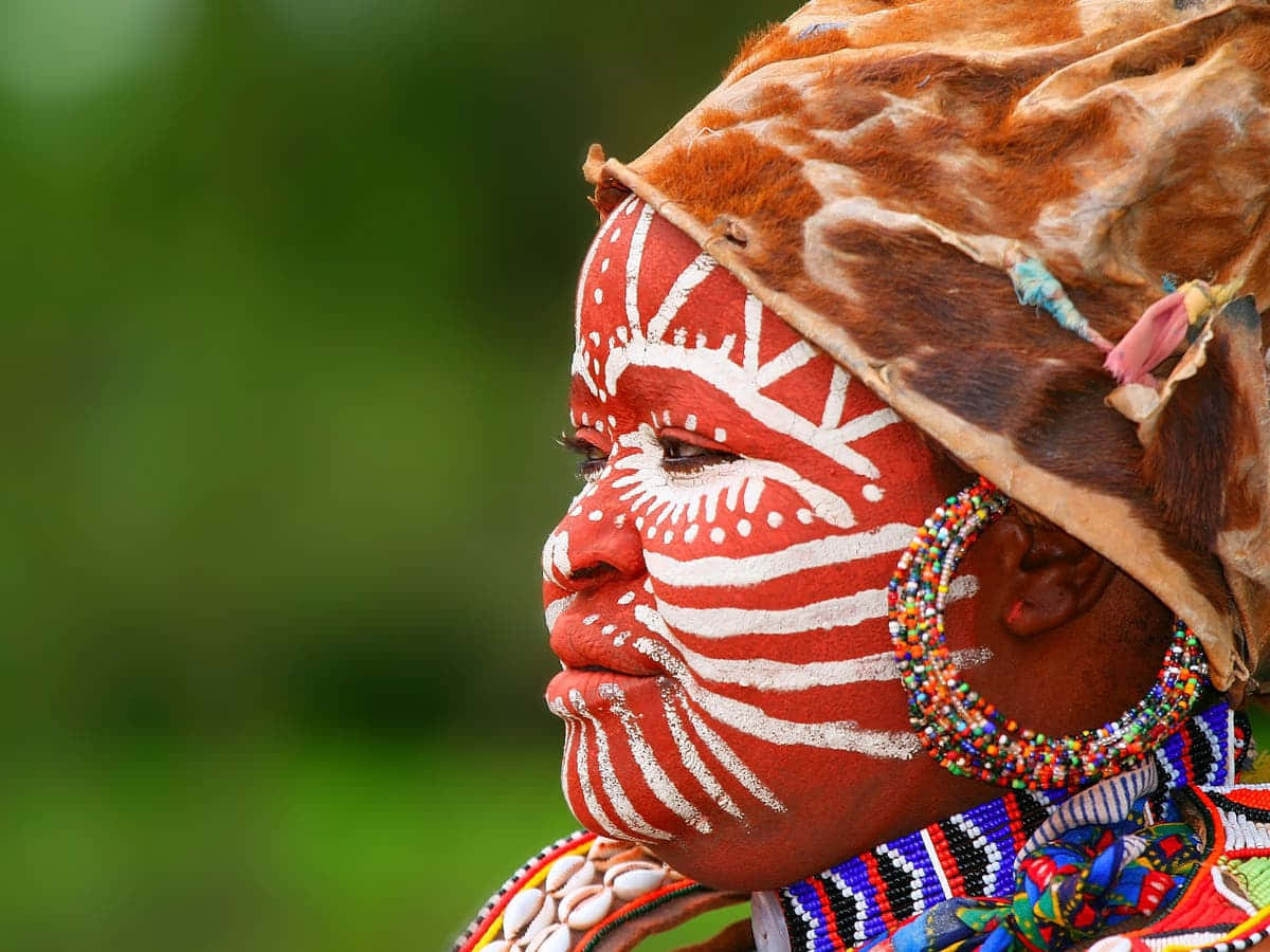 A Woman With Colorful Face Paint And A Headdress