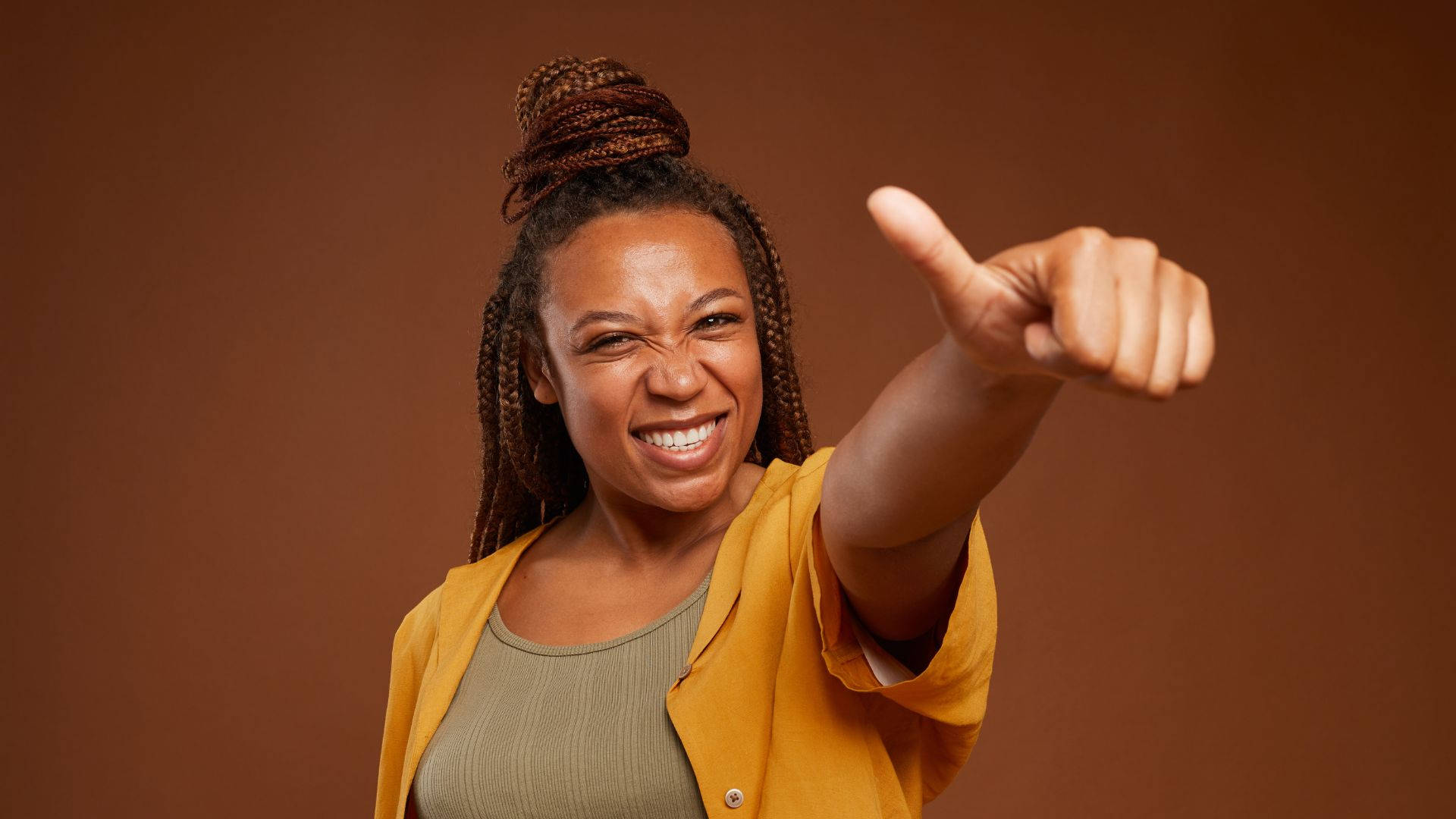 Empowered African Woman Giving Thumbs Up Wallpaper