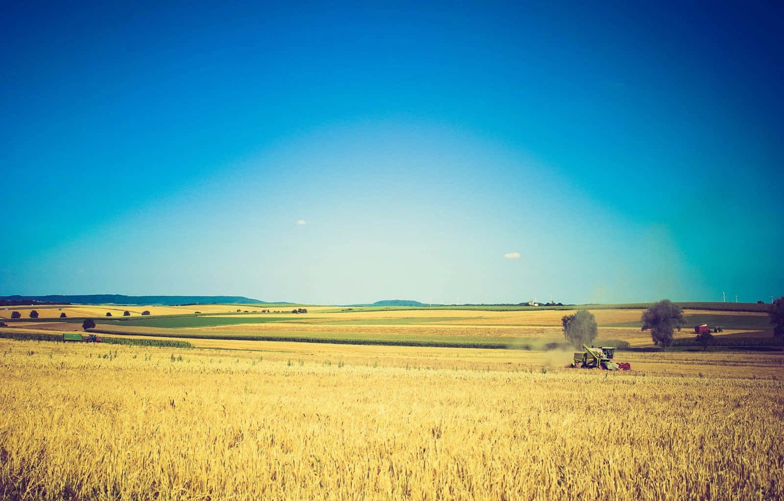 A Tractor Is Driving Through A Field