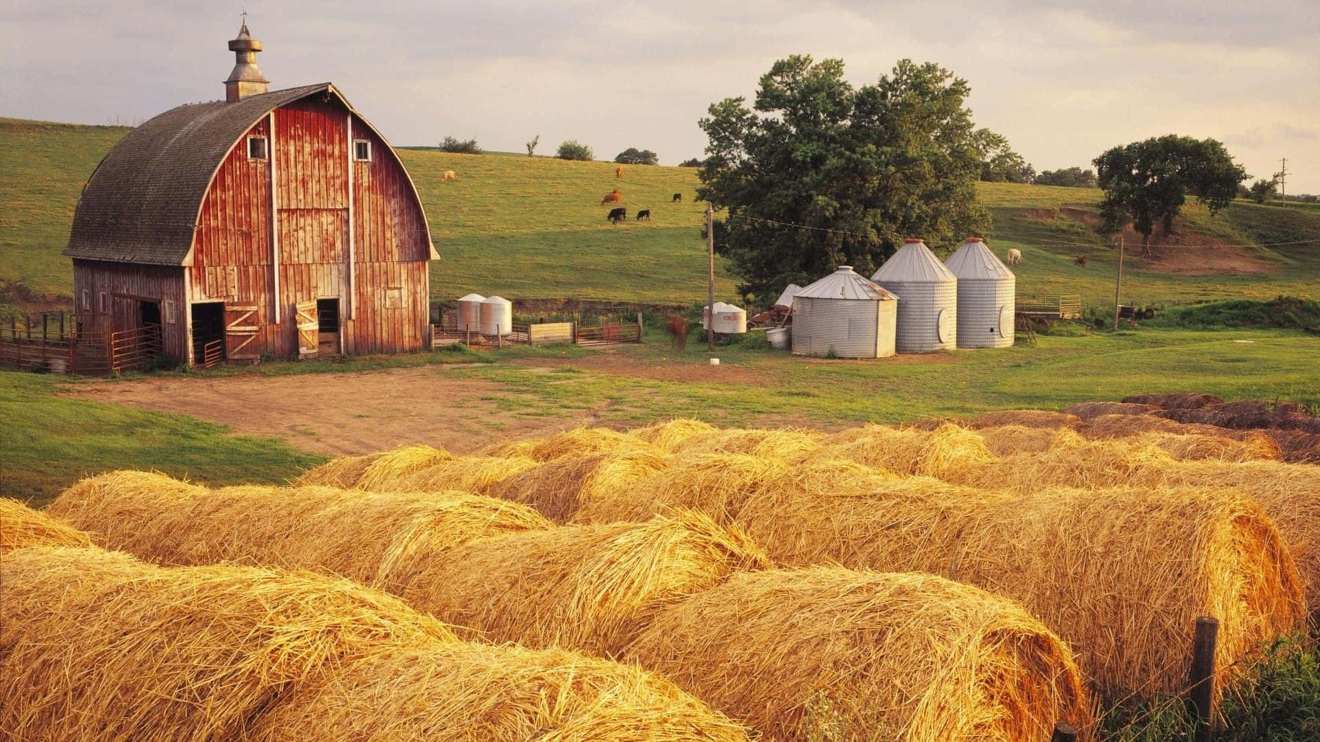 A Farm With Hay Bales And A Barn