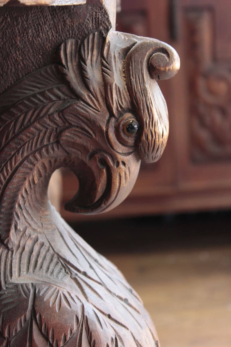 Artistic Wooden Aguila Sculpture in Building Environment Wallpaper