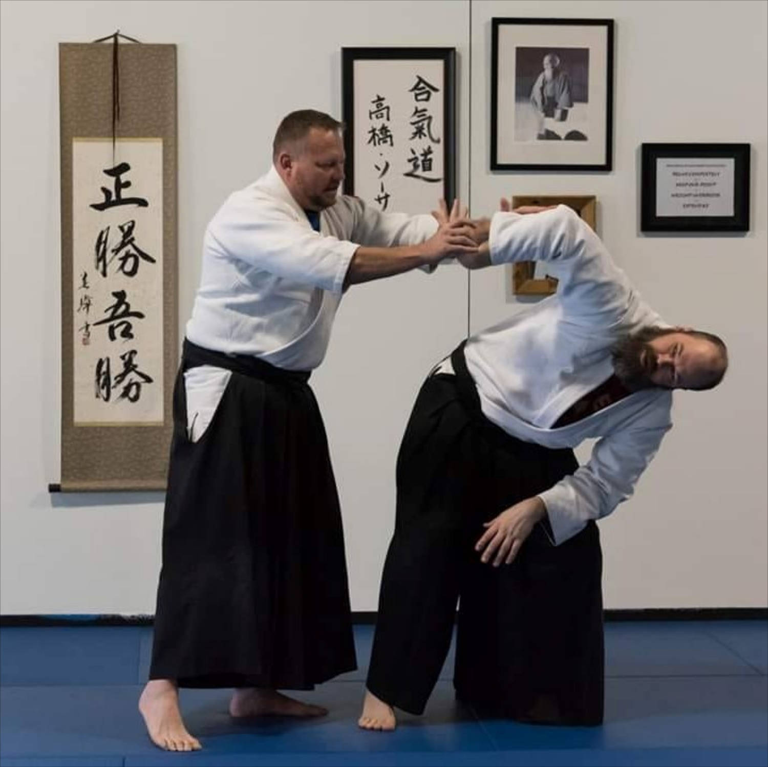 Aikido Practitioner Performing Sankyo Aikido Technique Wallpaper