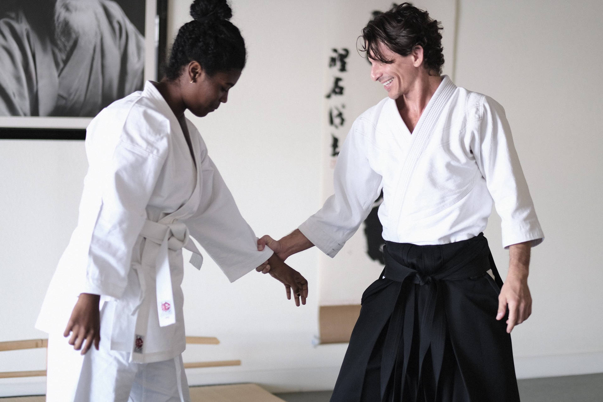 Aikido Sensei In Dojo Teaching Traditional Techniques Wallpaper