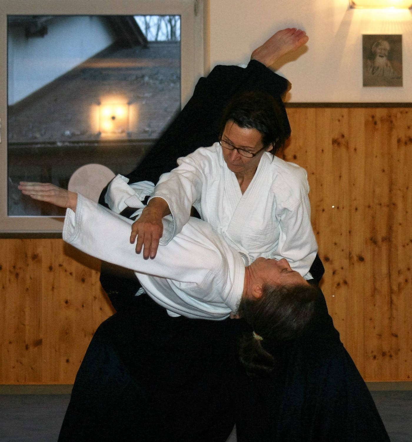 Aikidoka Performing Koshi Nage Aikido Technique Wallpaper
