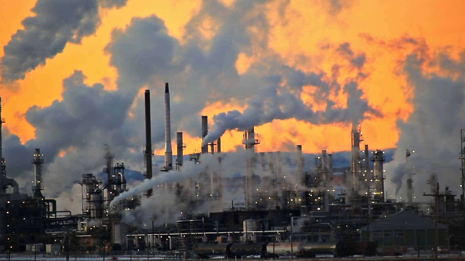 A Refinery With Smoke Coming Out Of It