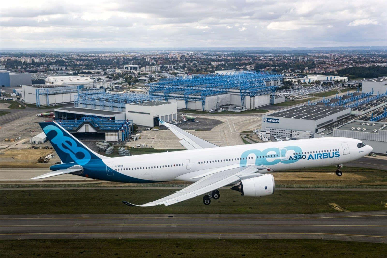 Airbus A330 Taking Off Near Industrial Facility Wallpaper