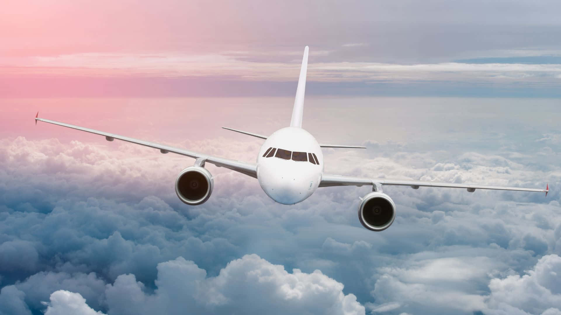 White Airplane Flying On Clouds Background