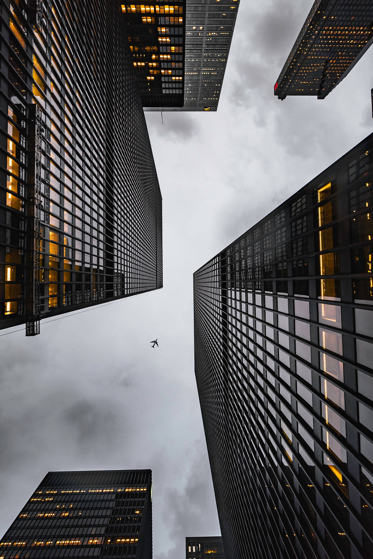 Airplane Flying Over Skyscrapers